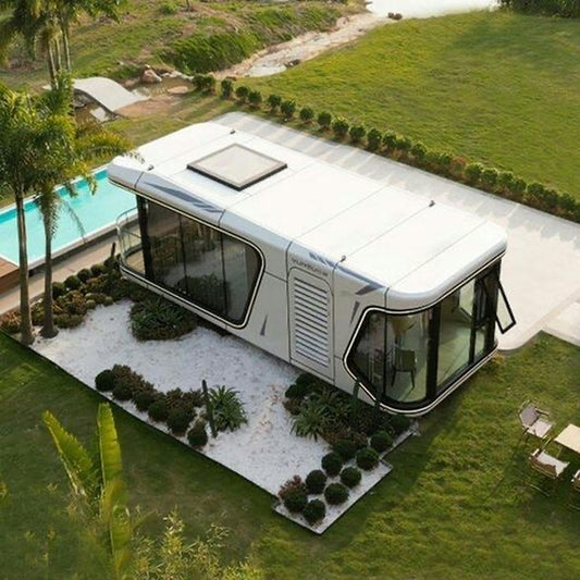 Modern mobile home with large windows in grassy yard